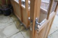 Inviting open door entrance of Cedar Rustic T-Garden Cross Greenhouse showcasing easy accessibility
