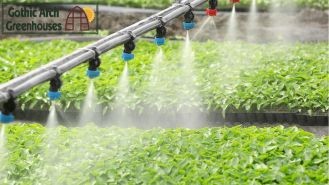 A misting system dispersing fine water droplets inside a greenhouse, effectively cooling the air.